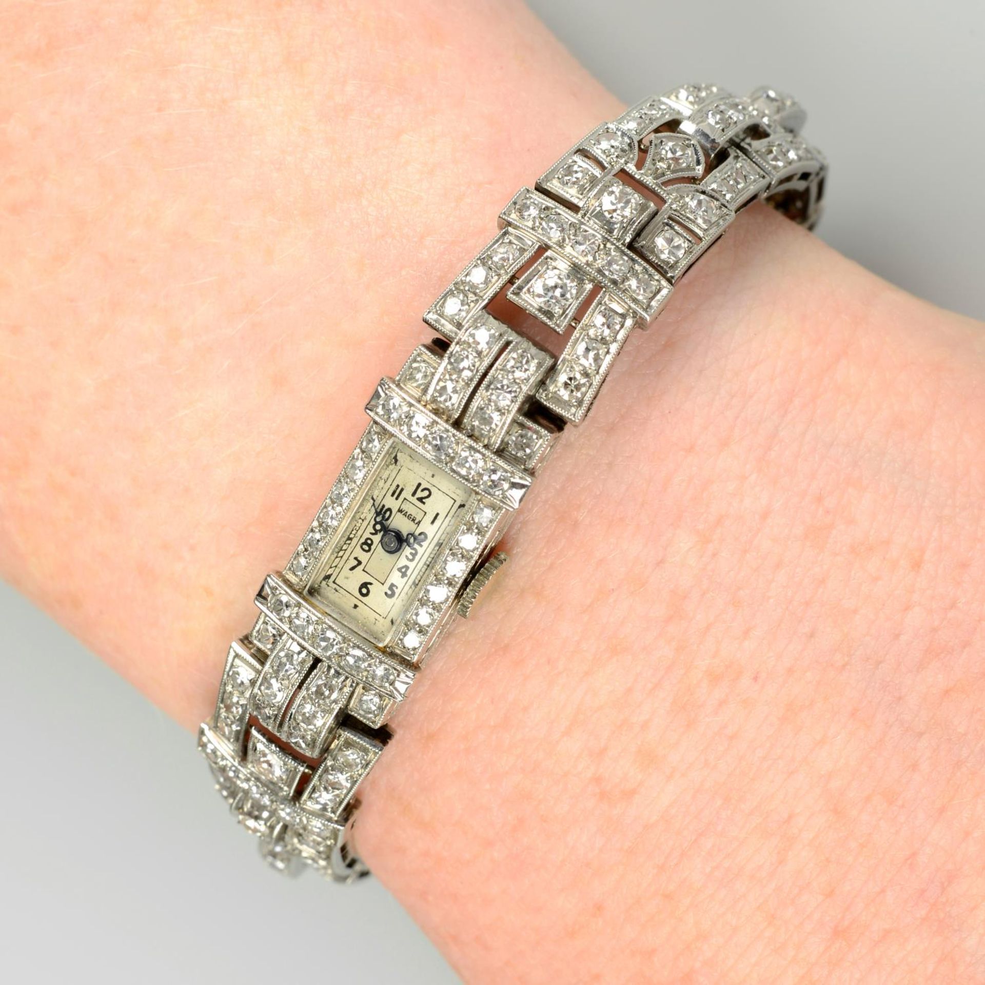 An Art Deco platinum pavé-set diamond cocktail watch.