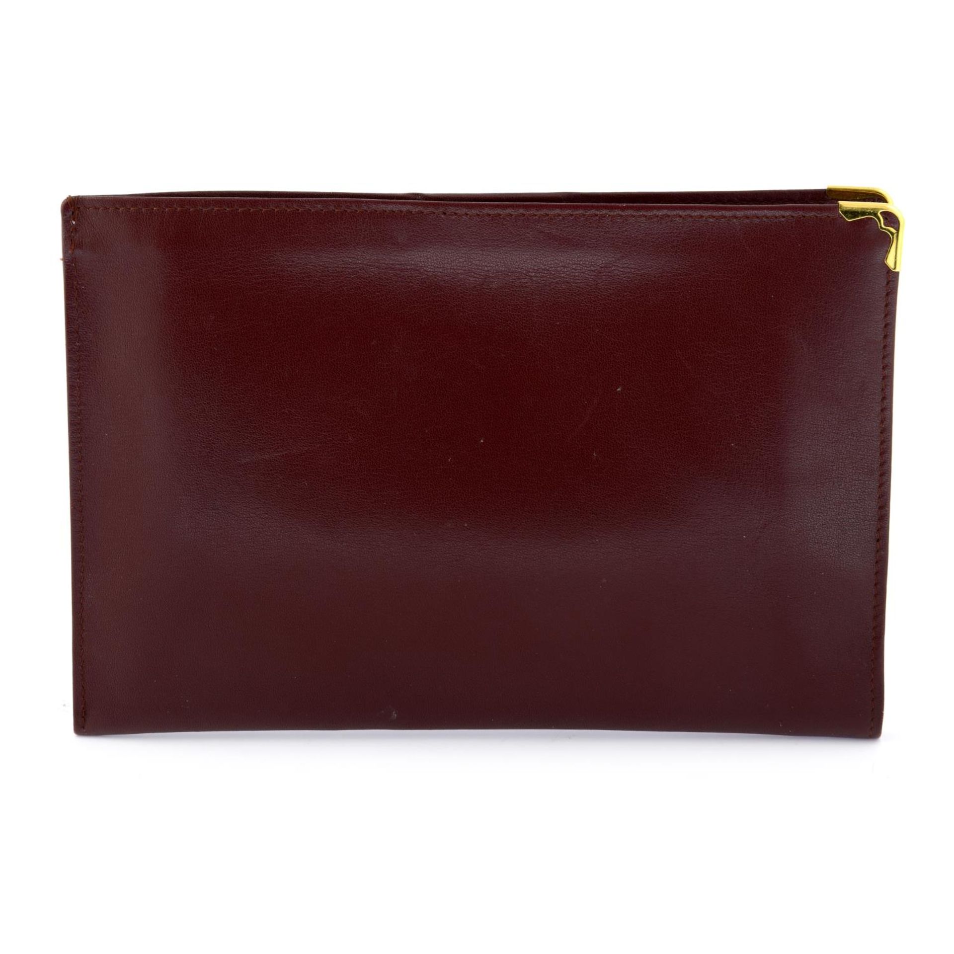 CARTIER - a Bordeaux leather purse. - Image 2 of 3