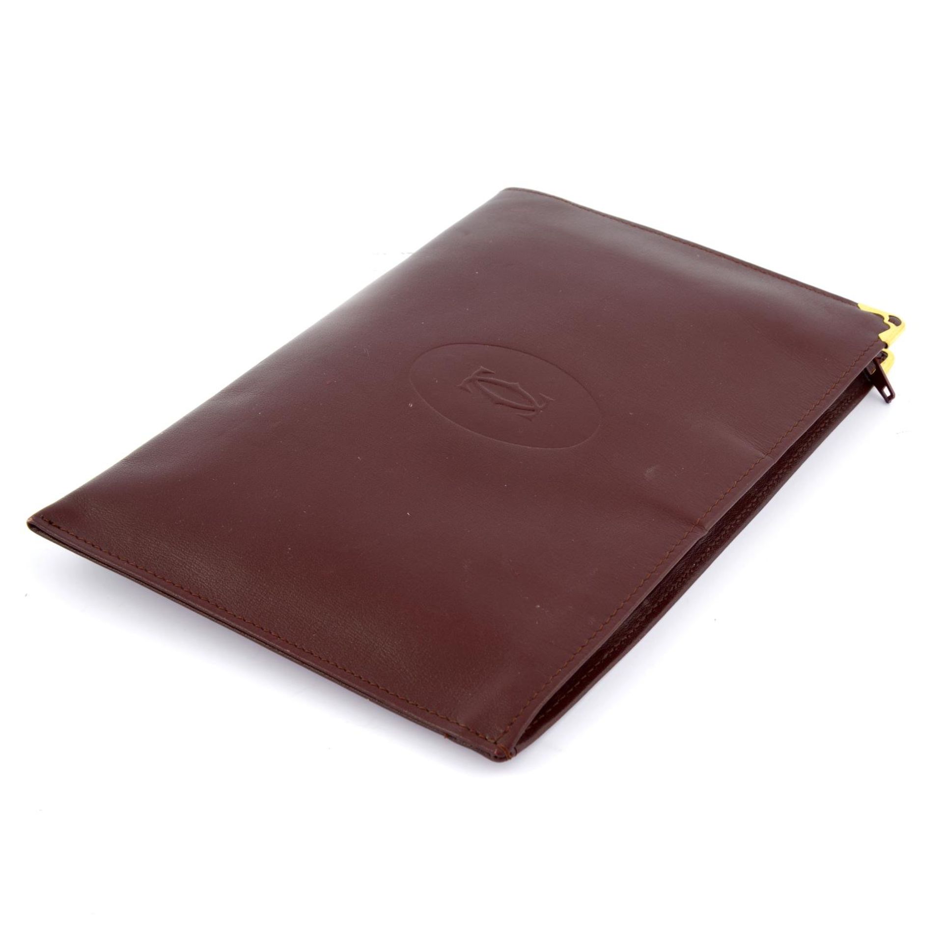 CARTIER - a Bordeaux leather purse. - Image 3 of 3