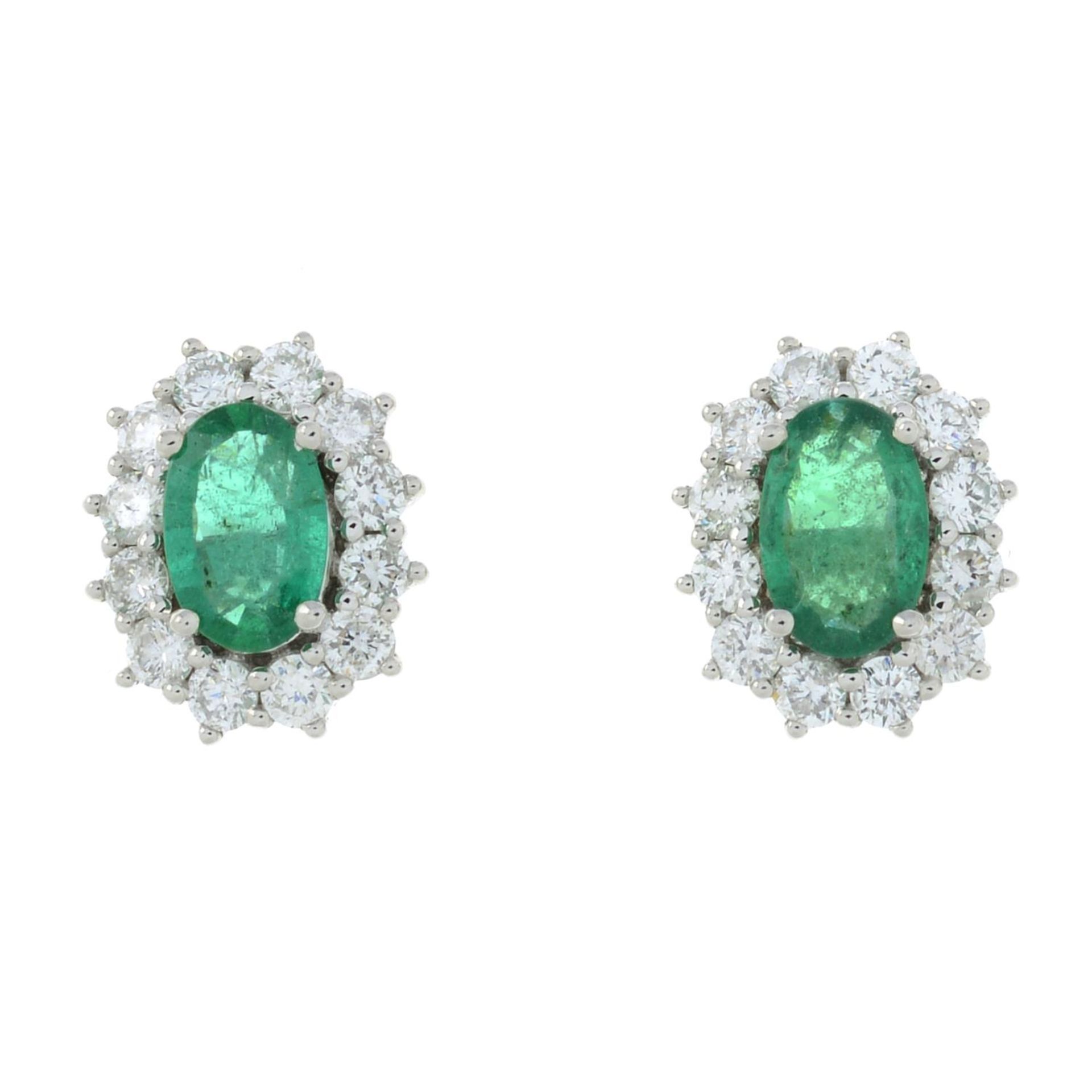 A pair of 18ct gold emerald and diamond cluster stud earrings.Total emerald weight 0.59ct.