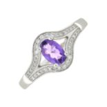 An 18ct gold amethyst and diamond dress ring.Estimated total diamond weight 0.15ct.