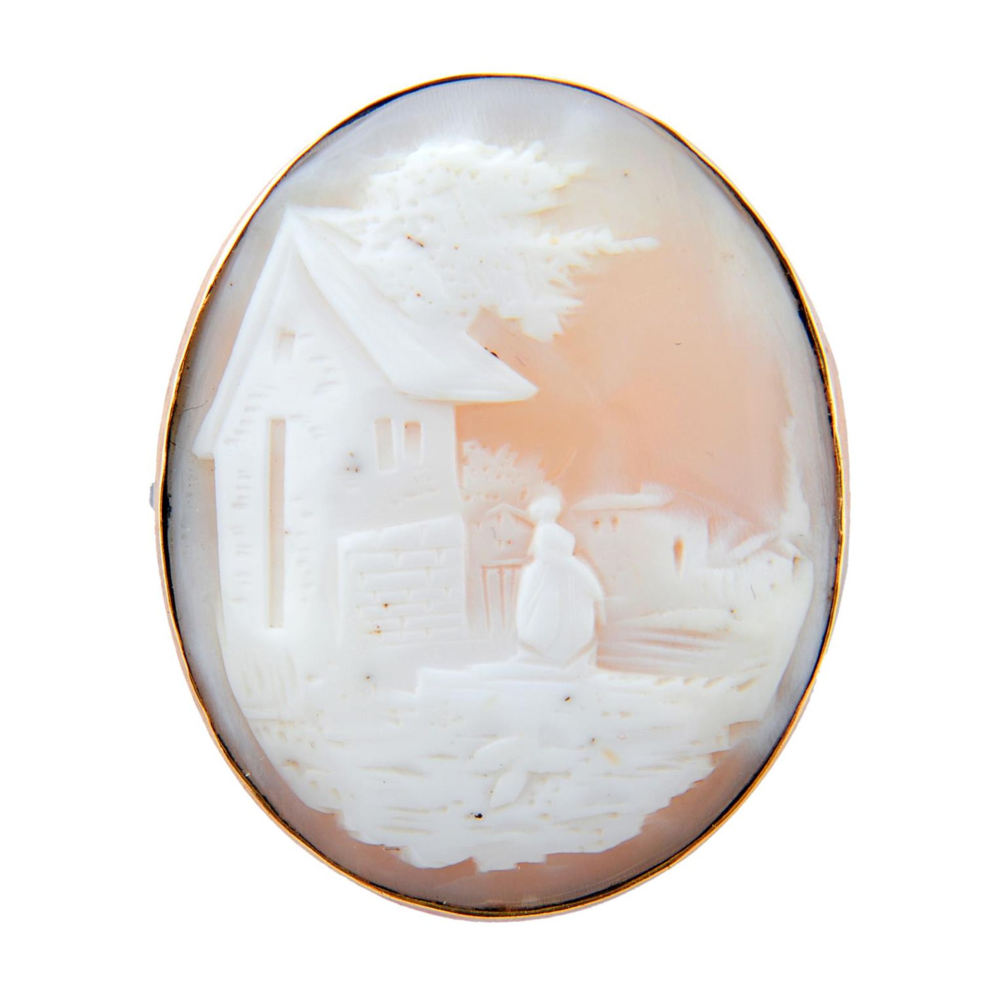 A shell cameo brooch featuring a village scene.Length 4cms.