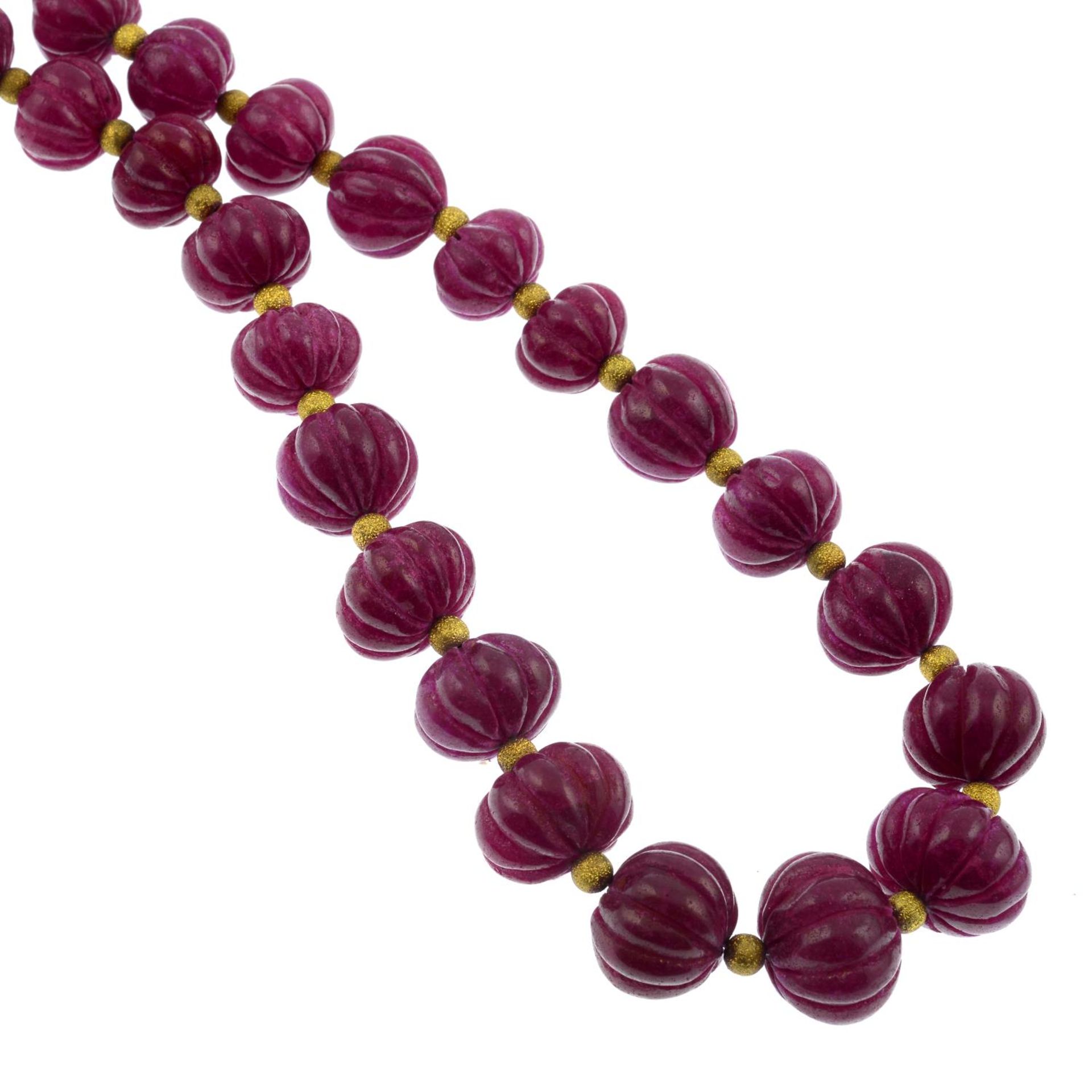 A glass-filled ruby bead necklace.Length 50.5cms.