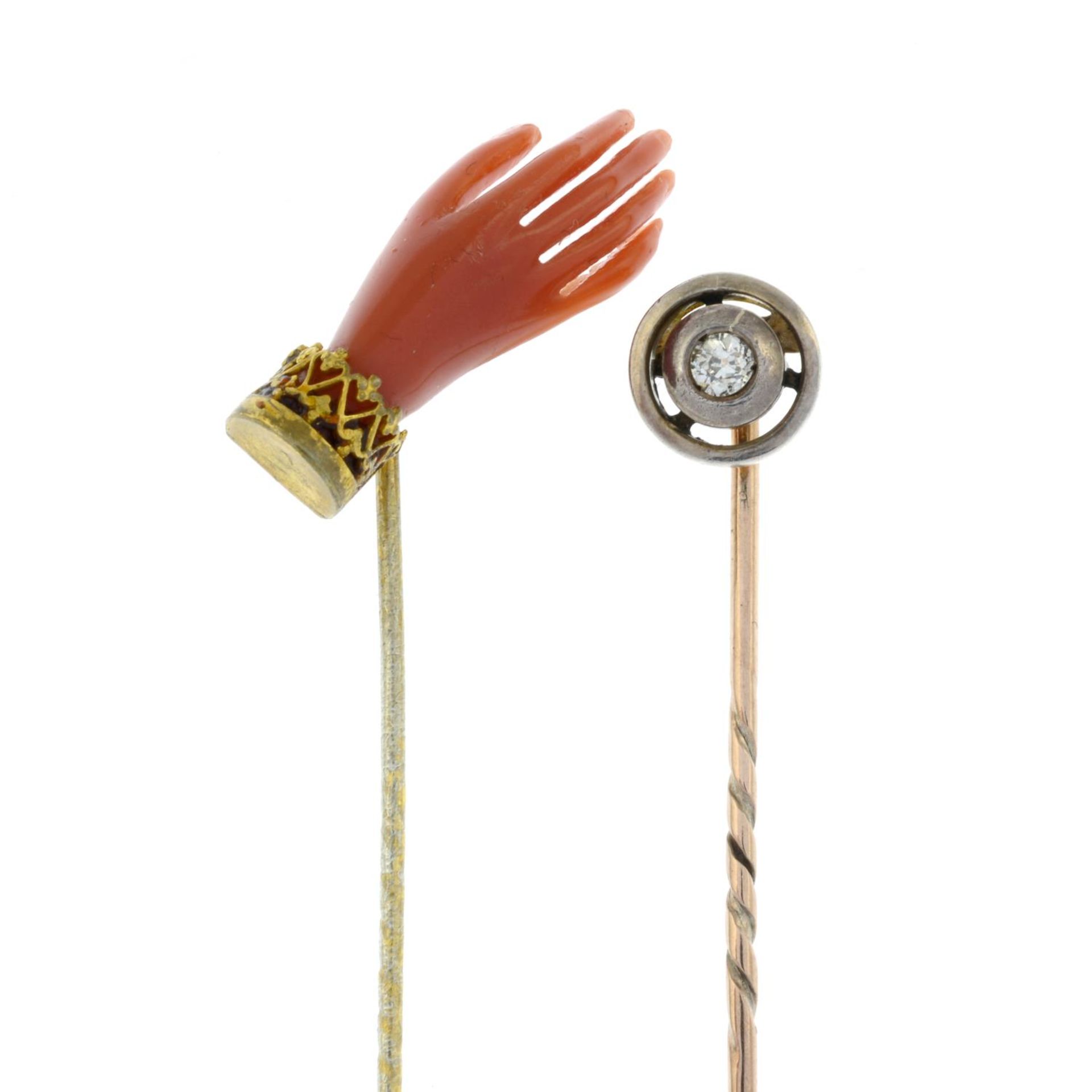 An old-cut diamond stickpin and a coral hand stickpin.Estimate diamond weight 0.1cts,