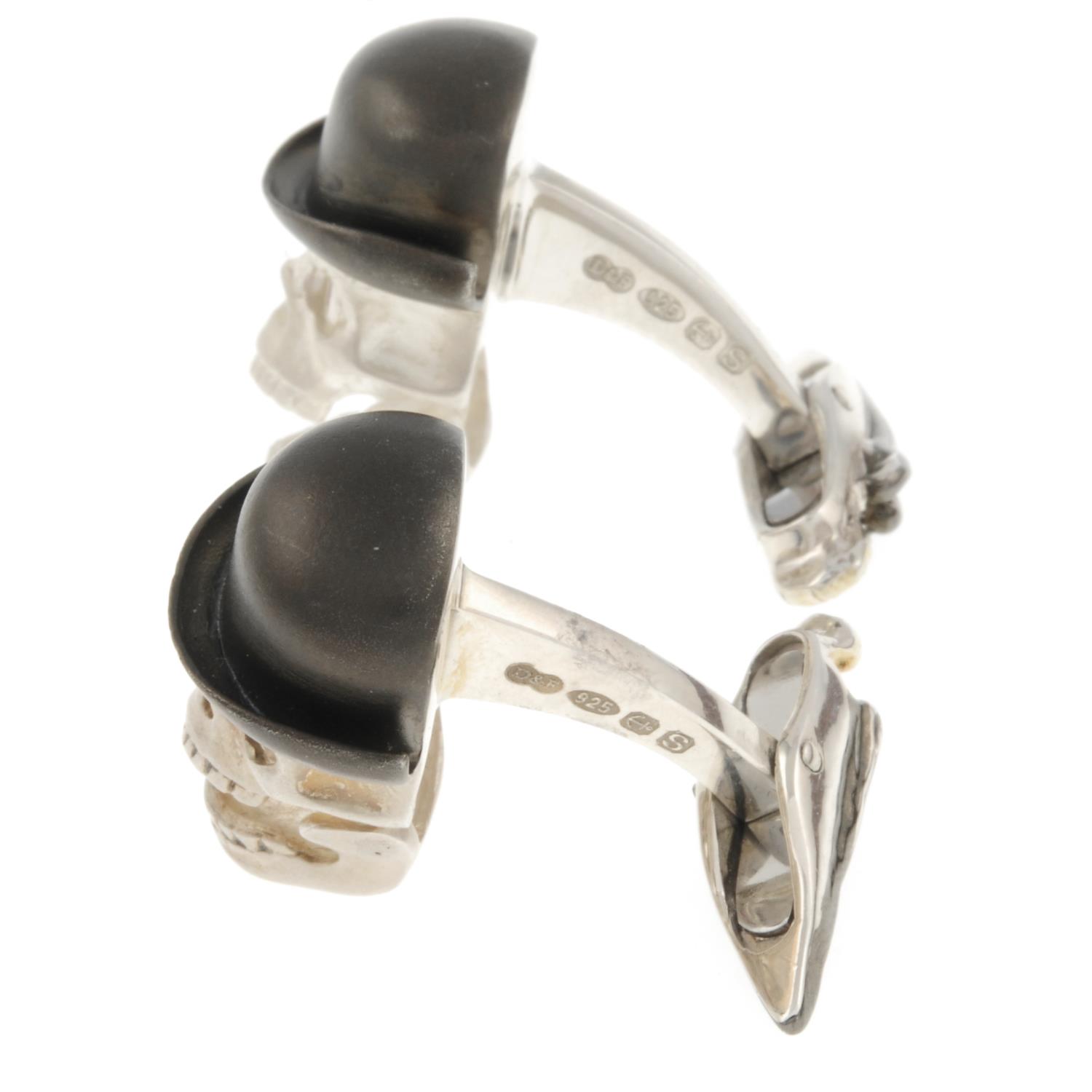 A pair of silver skull cufflinks, with articulated jaw and ruby eyes, by Deakin and Francis. - Image 2 of 3