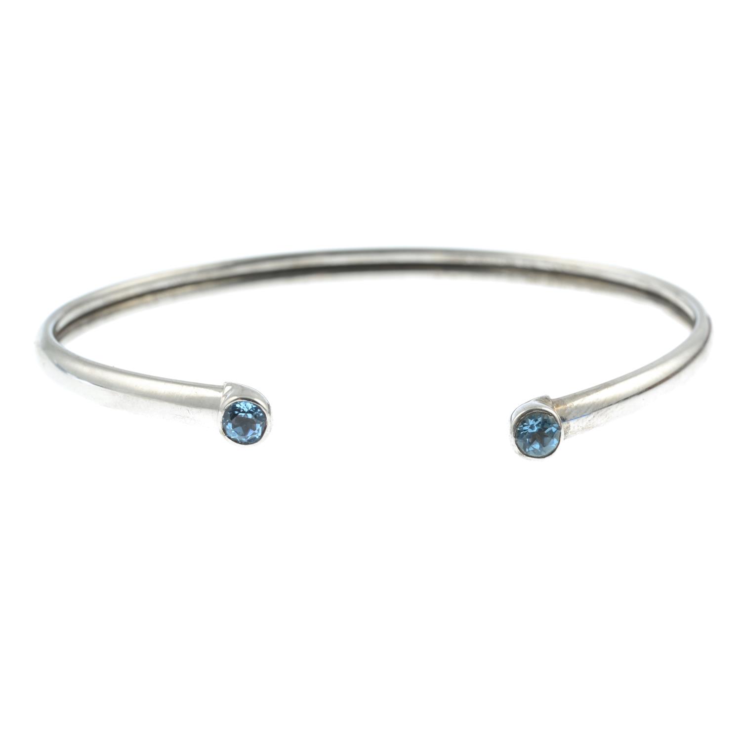 A 9ct gold topaz bangle.