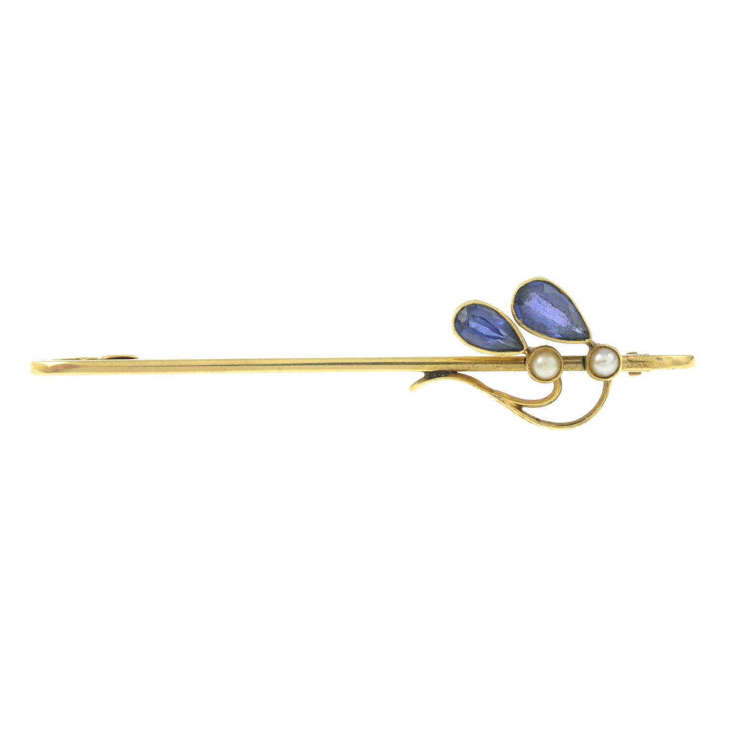 An early 20th century 15ct gold sapphire and split pearl foliate bar brooch.Stamped 15ct.Length
