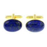 A pair of oval lapis lazuli cufflinks.Length of cufflink face 1.9cms.