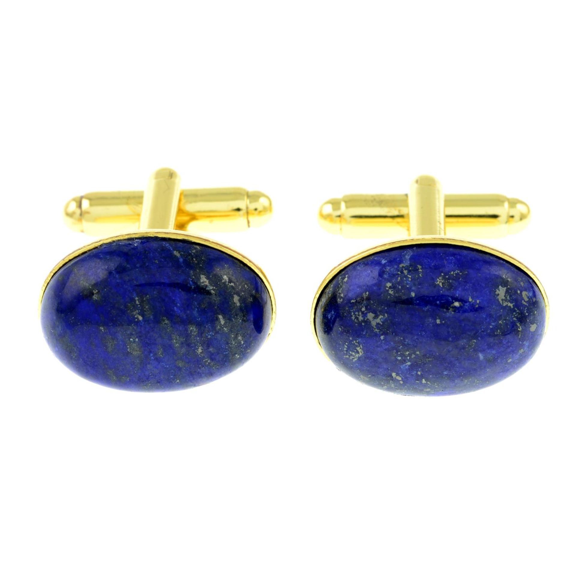 A pair of oval lapis lazuli cufflinks.Length of cufflink face 1.9cms.