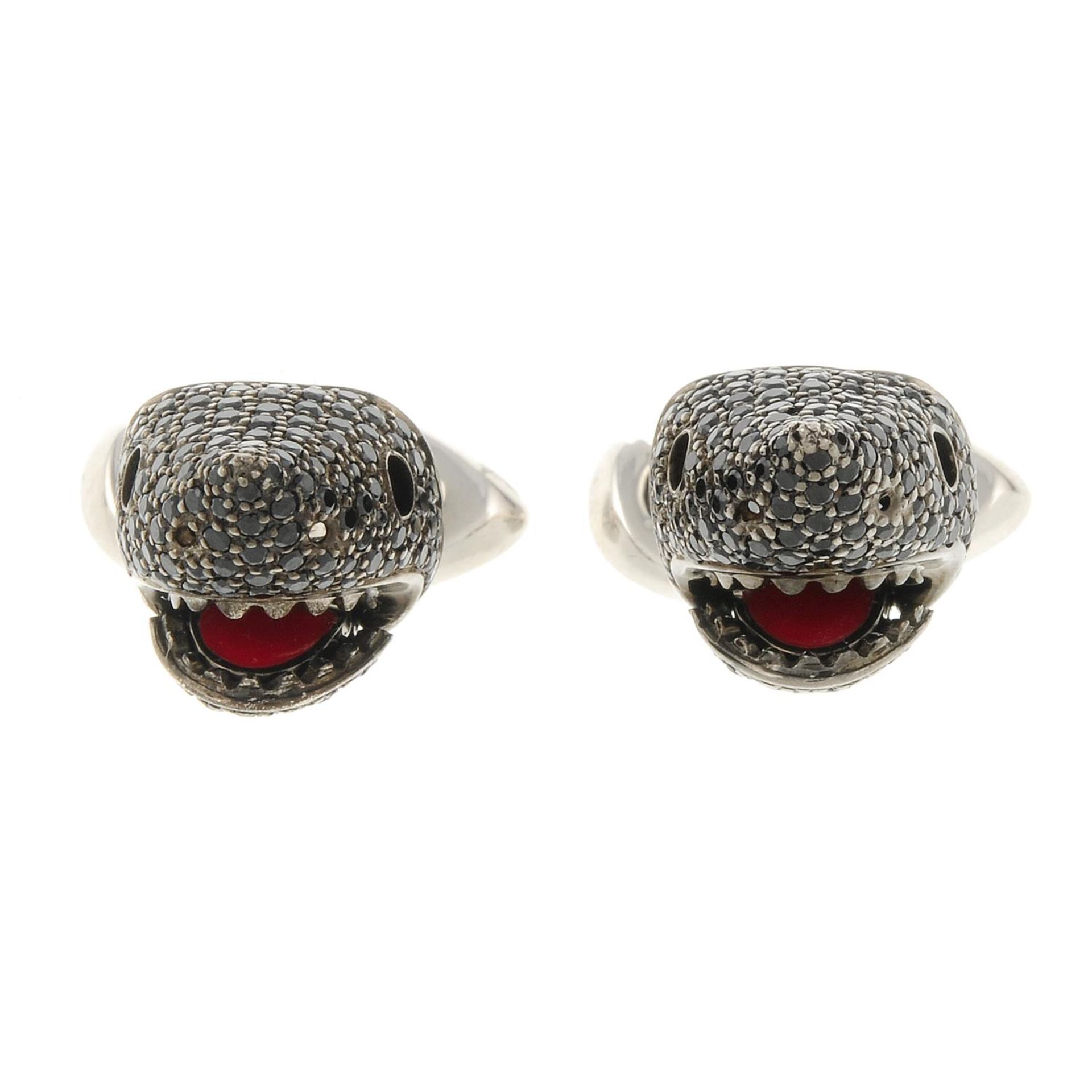 A pair of silver and black spinel shark head cufflinks,