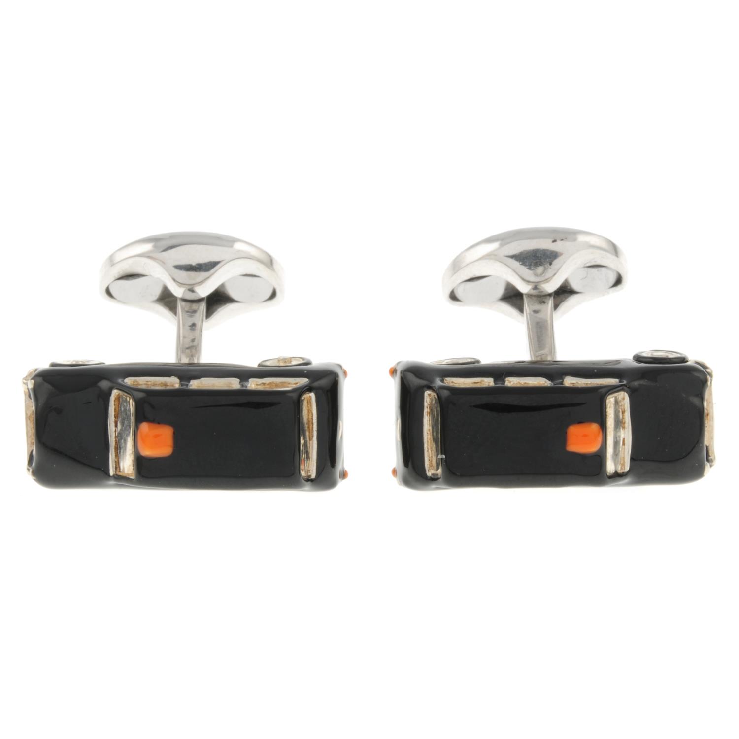 A pair of silver and enamel taxi cufflinks with rotating from wheels,