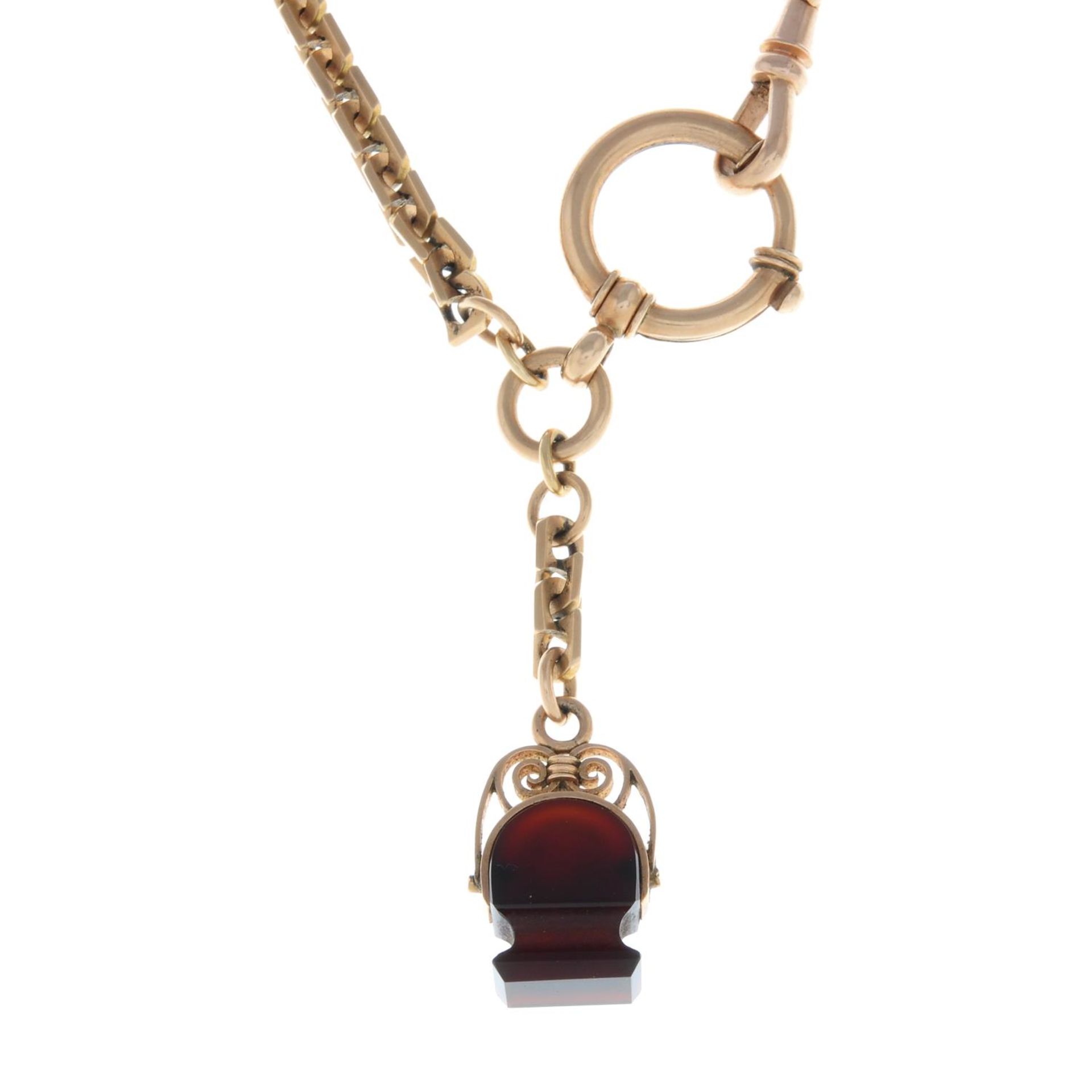 A fancy-link chain bracelet, suspending a carnelian fob.Stamped 585.Length 20cms.