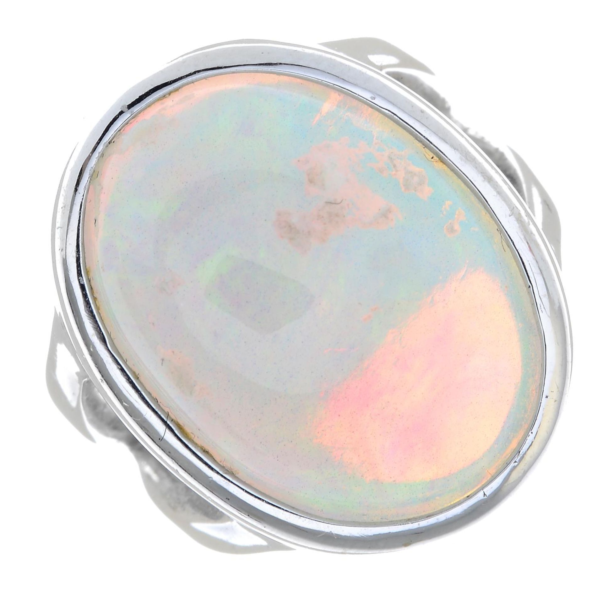 An opal cabochon single-stone ring.approximate dimensions of opal 21.2 by 15 by 11.2mms.Ring size