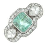 An emerald dress ring, with marquise-shape diamond sides, within a brilliant-cut diamond surround.