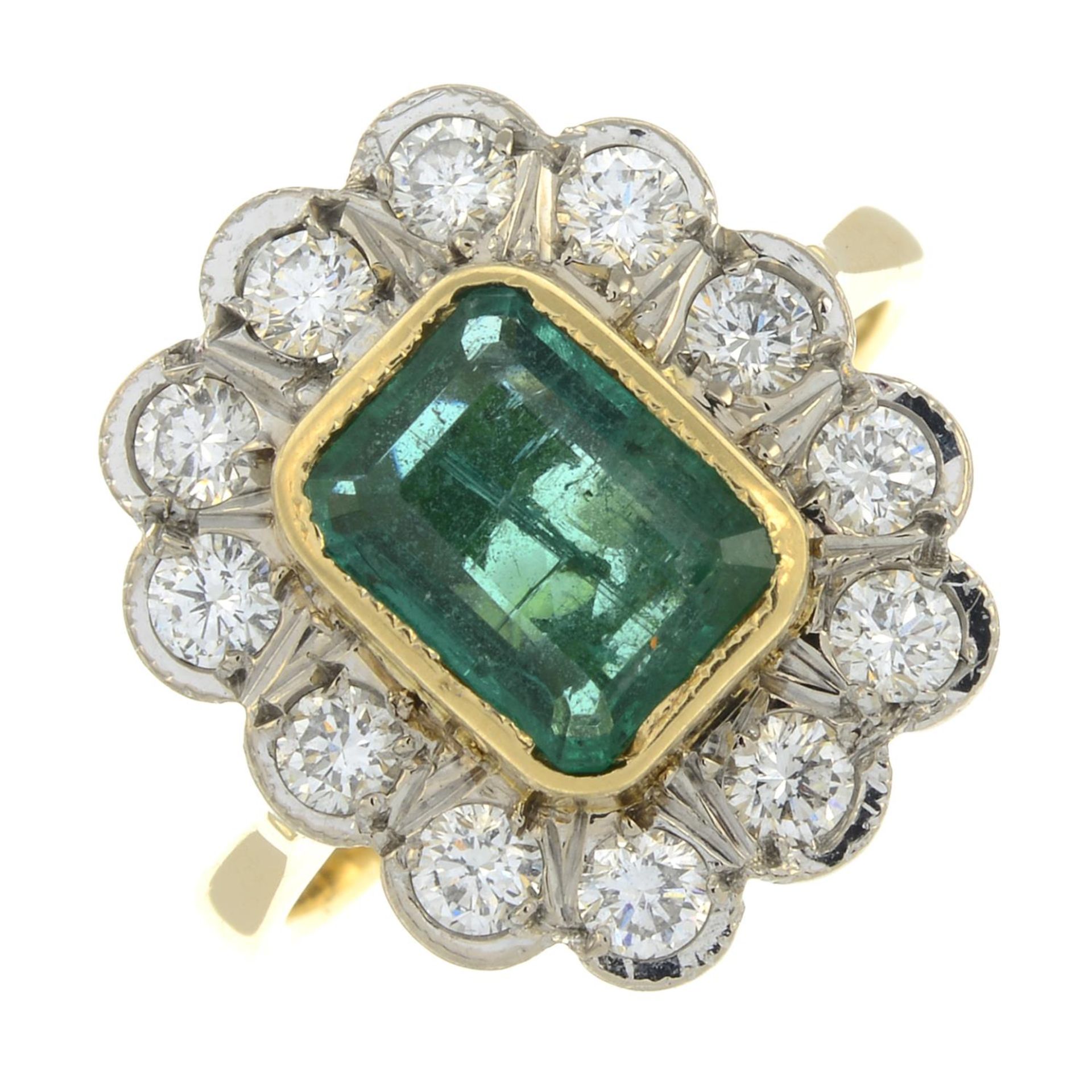 An 18ct gold emerald and diamond cluster ring.