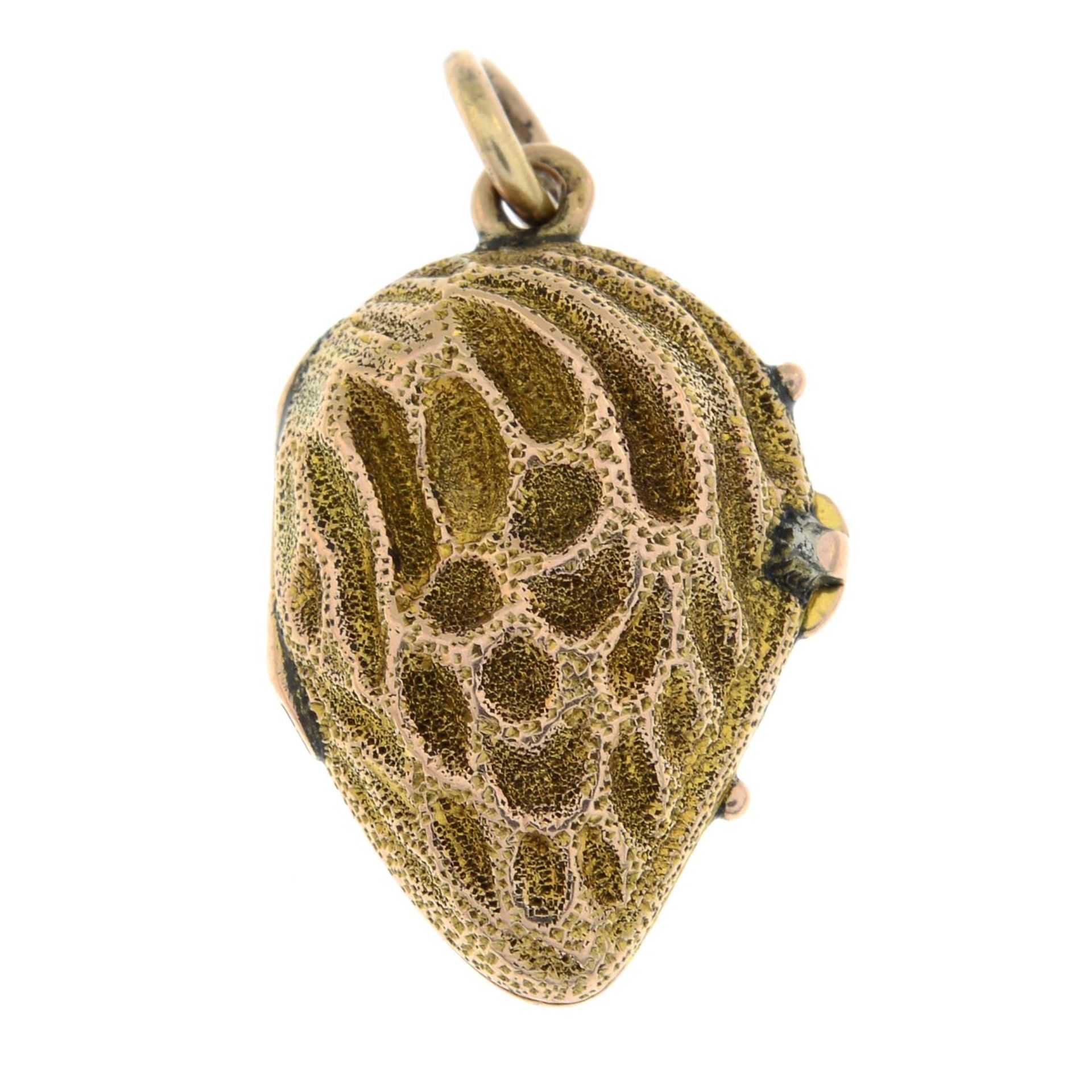 A late 19th century gold locket charm, designed as a stylised peach pip.Length 2.2cms. - Image 2 of 3