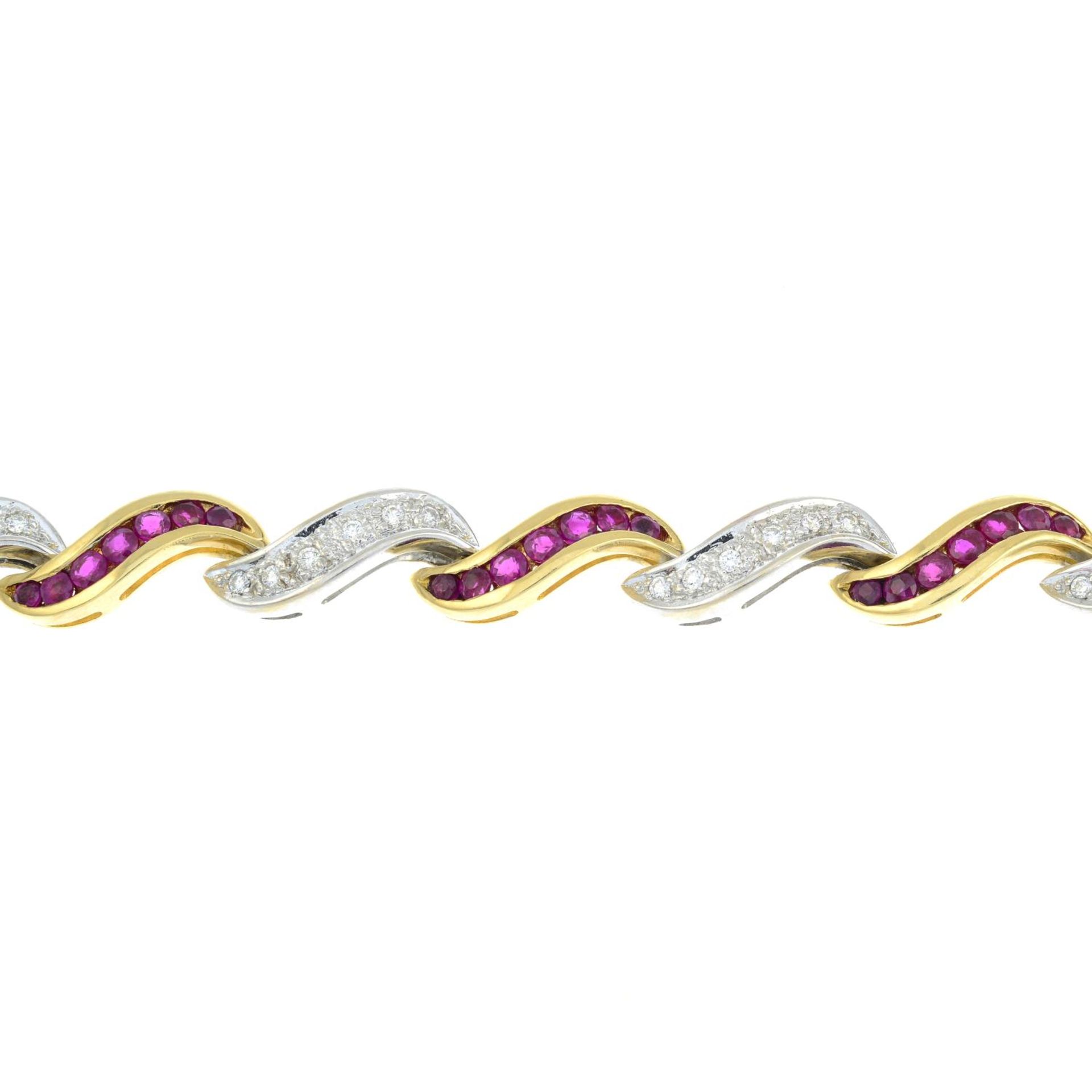 An 18ct bi-colour gold ruby and brilliant-cut diamond scrolling bracelet.Total ruby weight