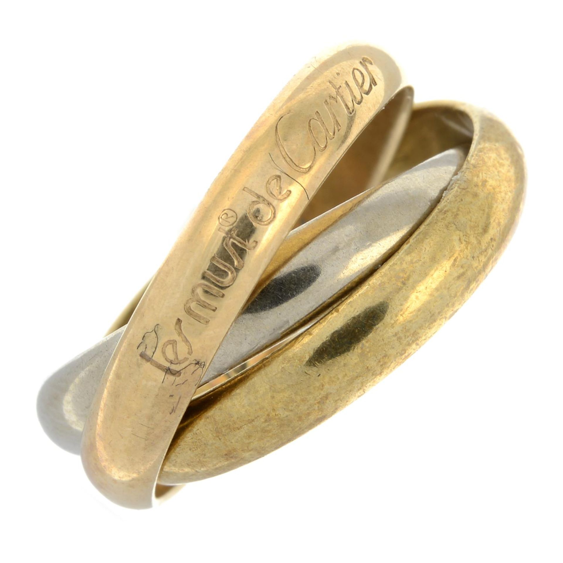 A 'les must de Cartier' trinity ring, by Cartier.Signed Cartier.Stamped 750.Ring size M1/2.