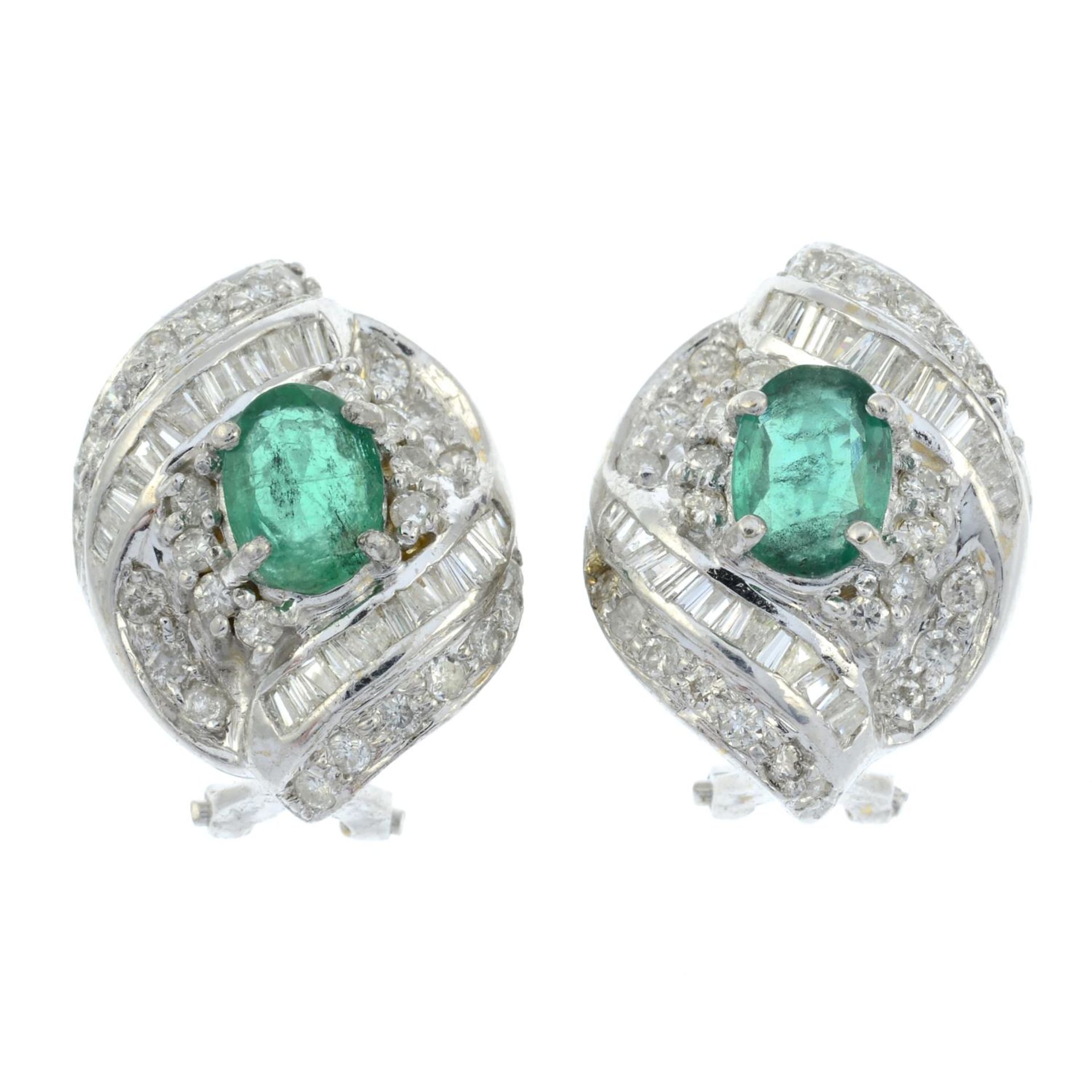 A pair of emerald and vari-cut diamond scrolling cluster earrings.