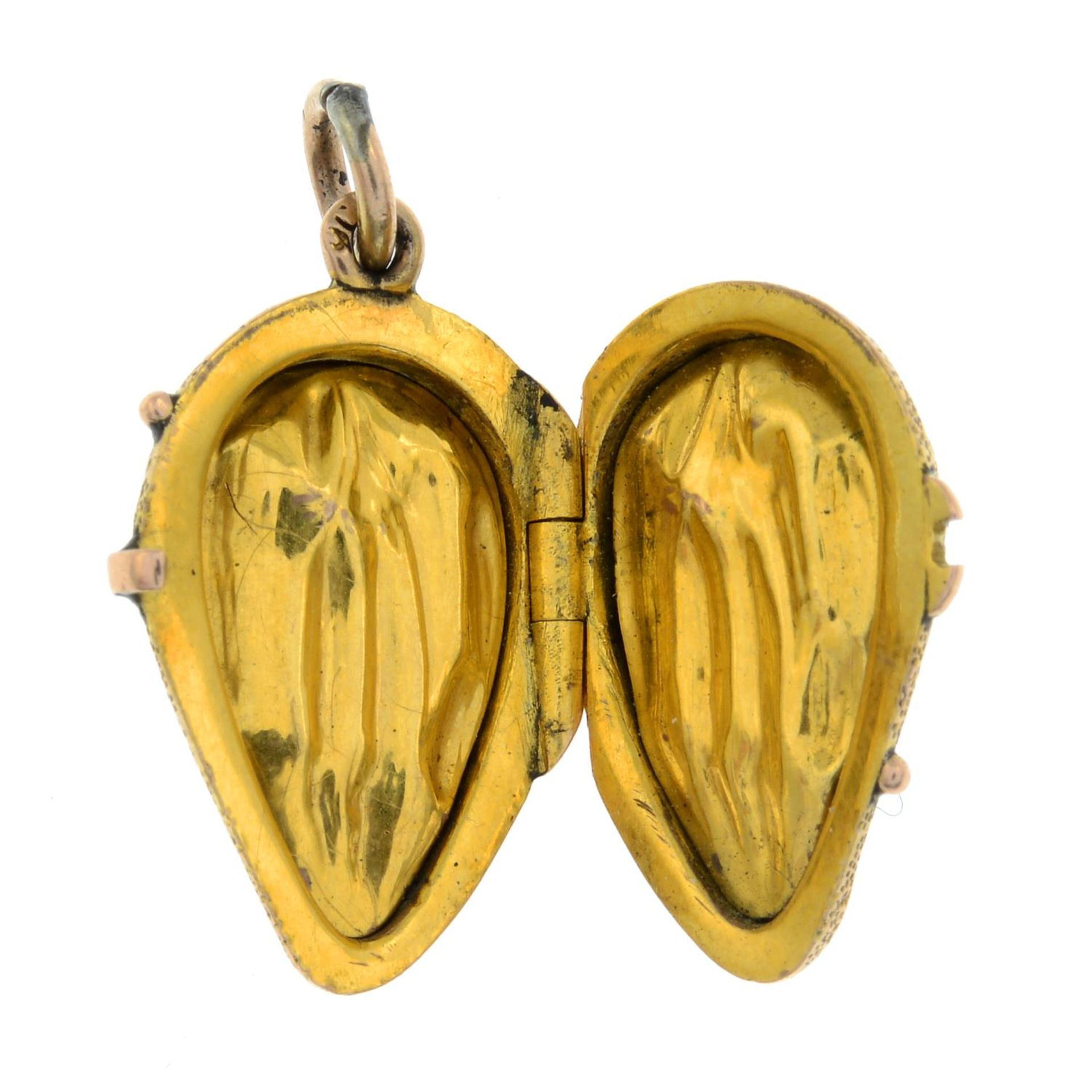 A late 19th century gold locket charm, designed as a stylised peach pip.Length 2.2cms. - Image 3 of 3