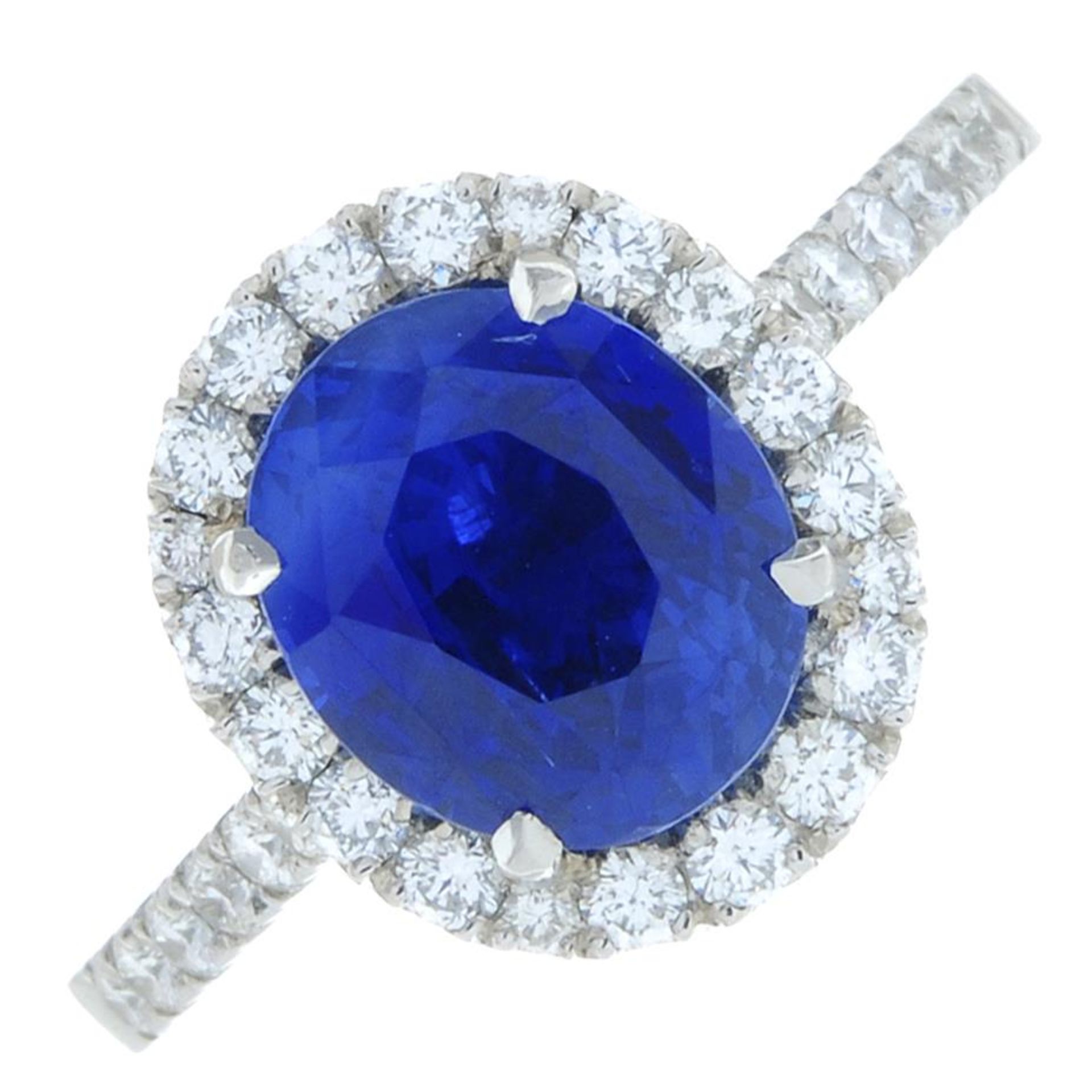 A platinum sapphire and brilliant-cut diamond cluster ring.Sapphire calculated weight 3cts,
