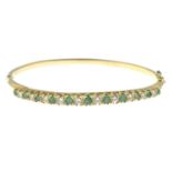 An emerald and diamond bangle, hinged to the plain reverse.