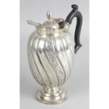 A late Victorian silver lidded jug or ewer,