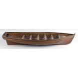 An early 20th century carved and stained wooden model boat,