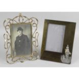 An Art Nouveau green stained wooden photograph frame,
