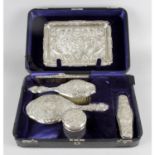 A cased Edwardian silver and silver mounted dressing table set,