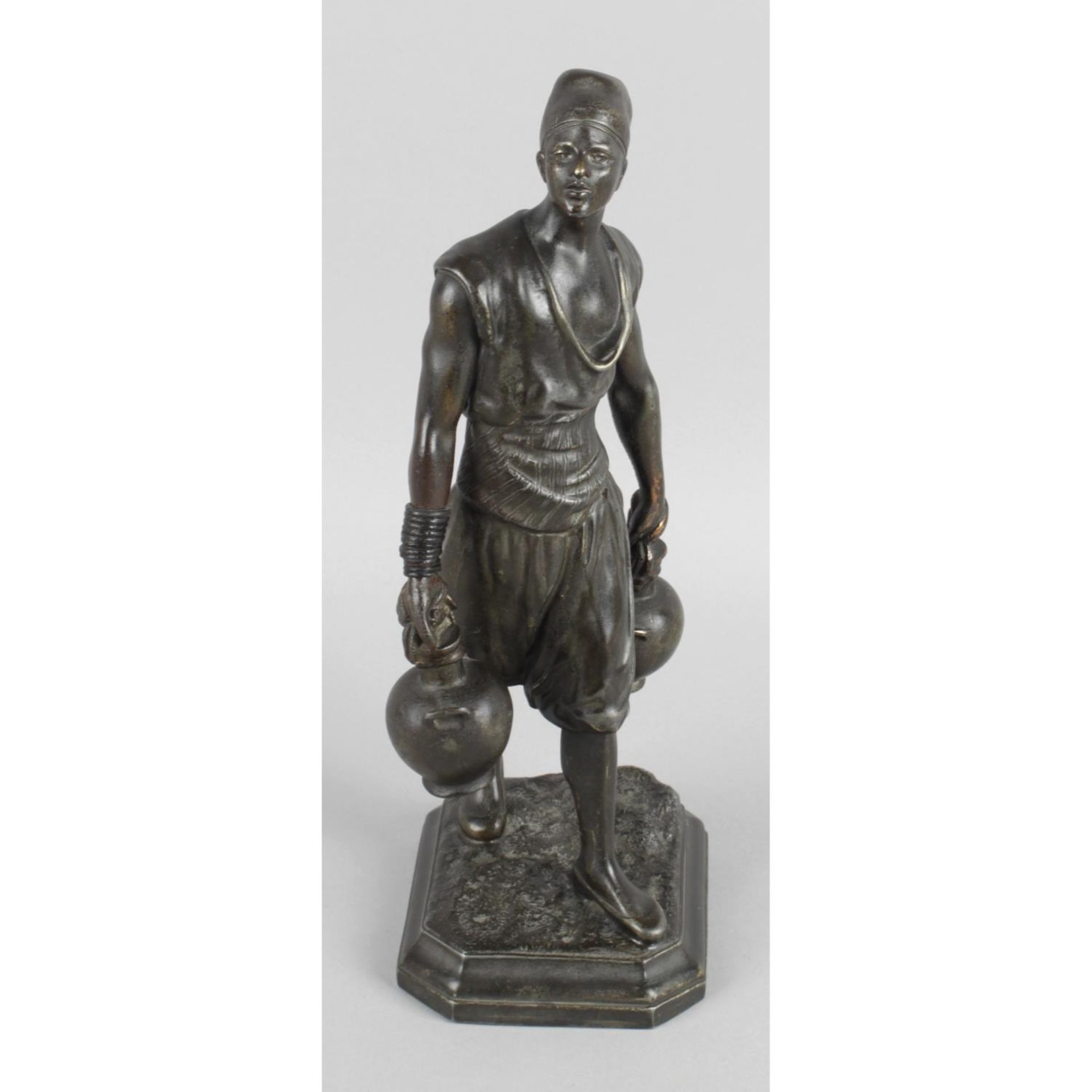 A late nineteenth century bronze figure modelled as an eastern male wearing Fez,