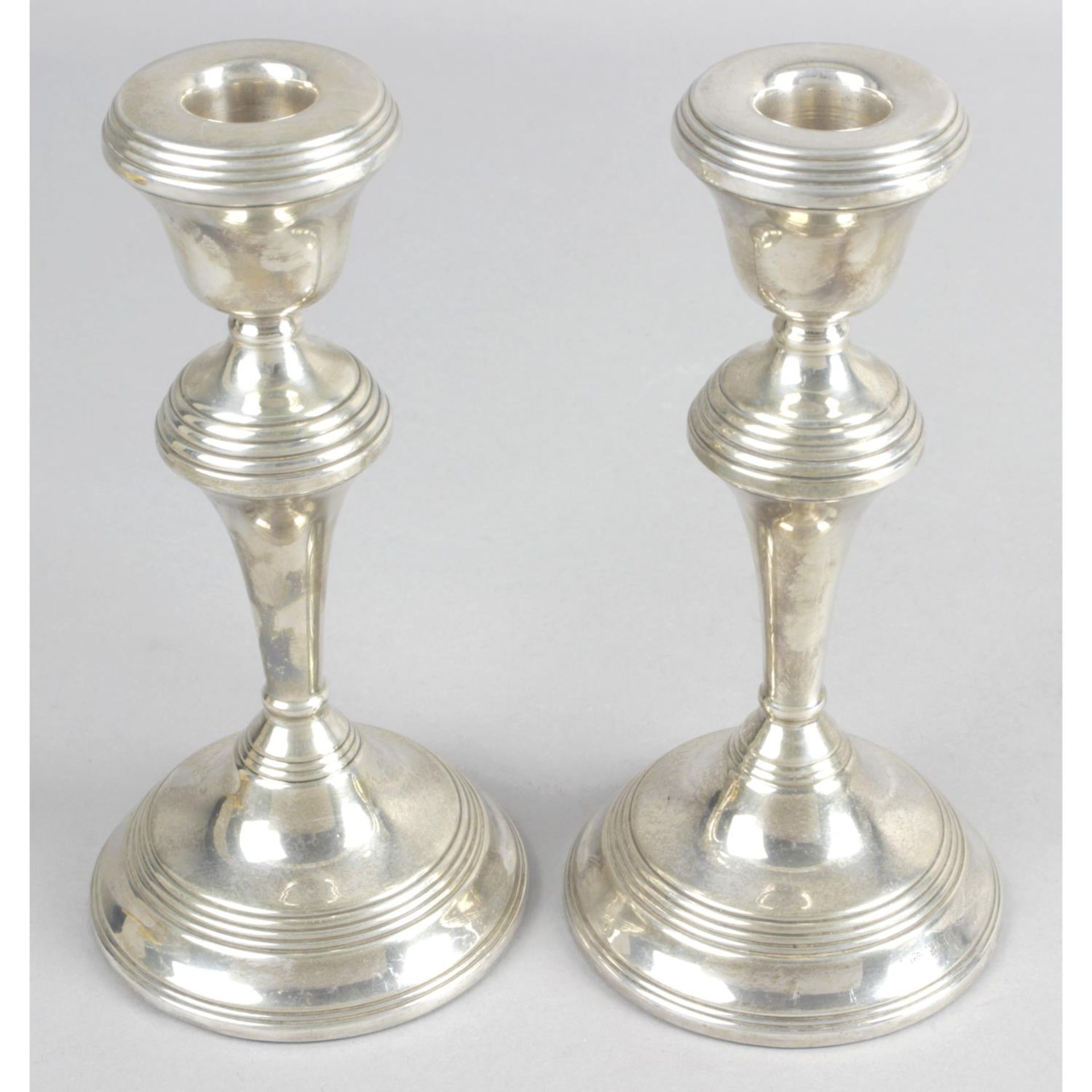 A pair of modern matched silver candlesticks,