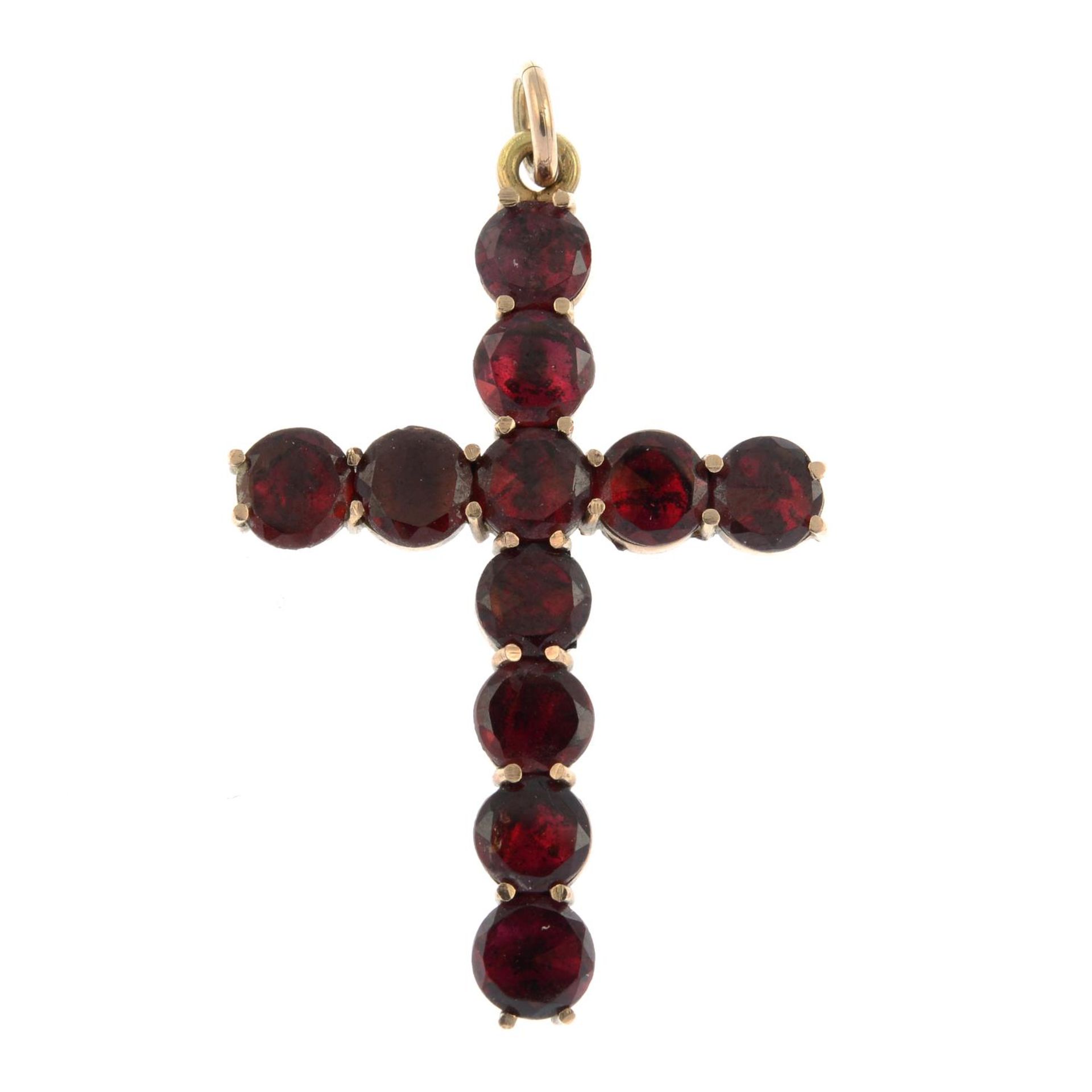 An early 20th century 9ct gold foil-back garnet cross pendant.Stamped 9ct.