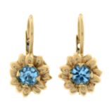 A pair of back-coated blue gem earrings.