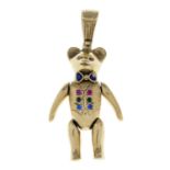 A teddy bear pendant, with articulated limbs, multi-hue paste buttons and painted bow.Length 6cms.