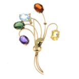 A gem-set stylised floral bouquet brooch.Gems to include amethyst,