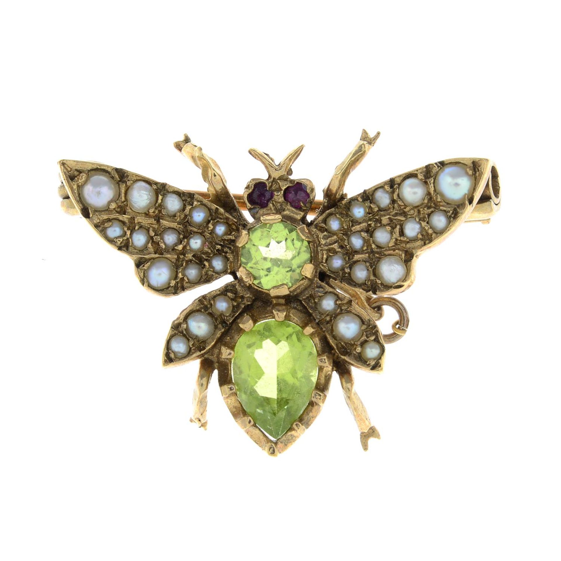 A 1980s 9ct gold peridot, ruby and split pearl winged insect brooch.Hallmarks for London, 1982.