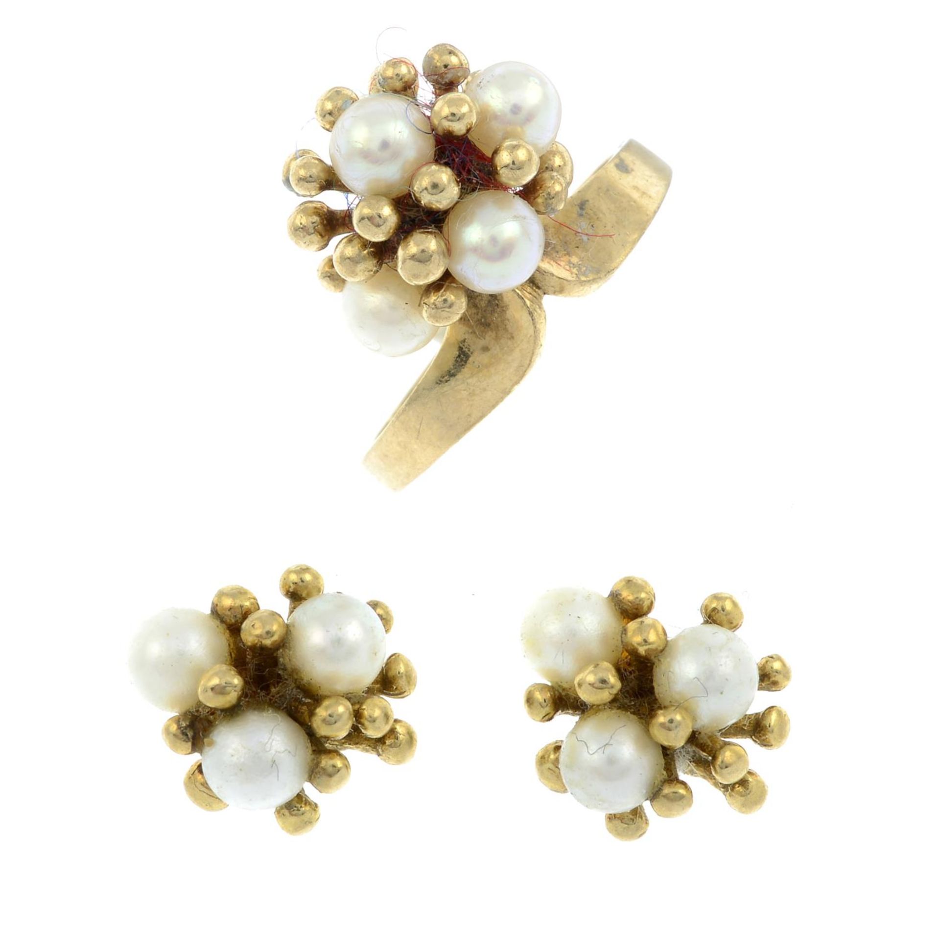 A 9ct gold cultured pearl ring designed as a stylised flower and a pair of matching stud earrings.