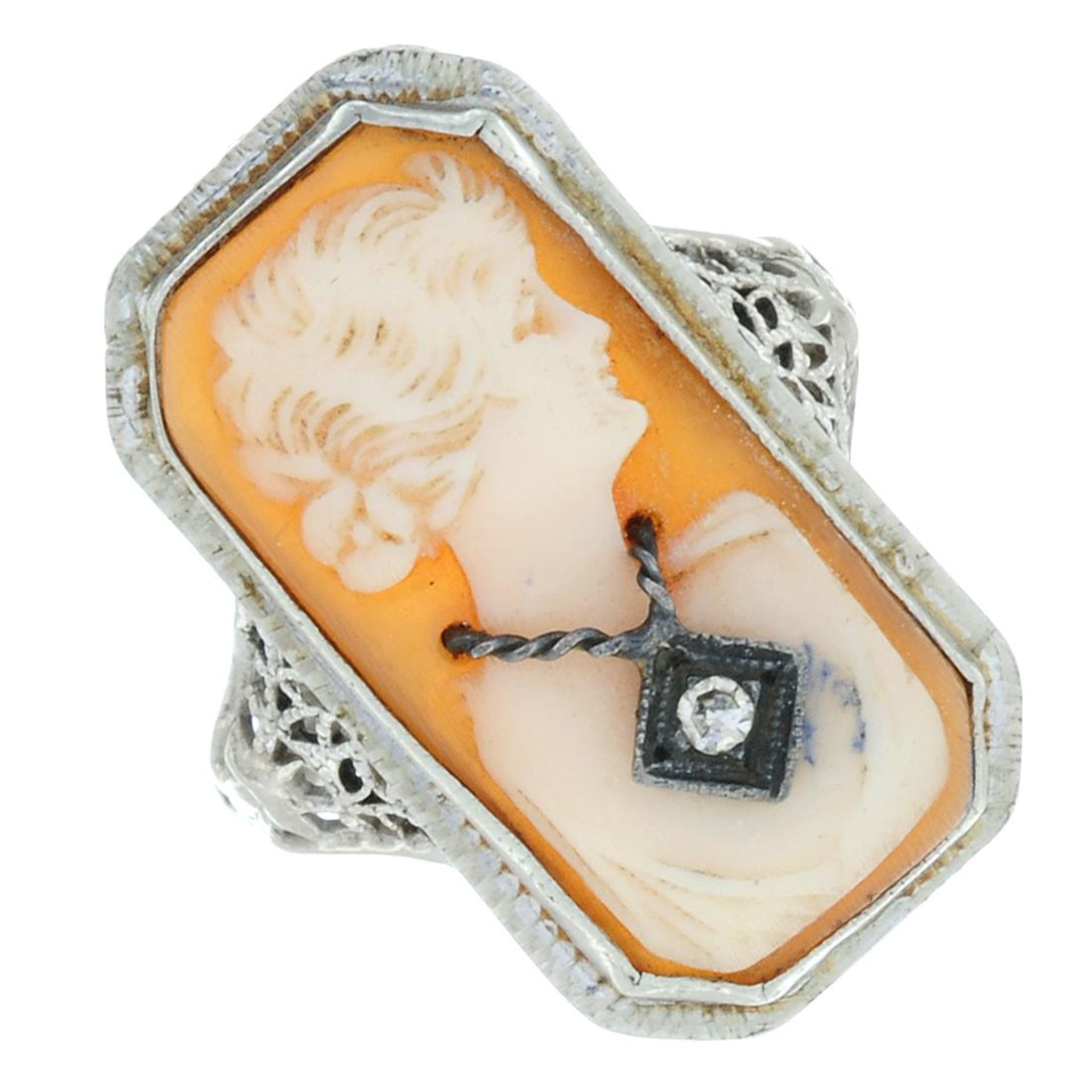 An early 20th century diamond and shell cameo filigree ring,