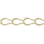 A fancy-link bracelet, designed as a series of horseshoe links.Clasp AF.