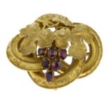 A mid 19th century gold garnet grape and vine brooch.Length 4.5cms.