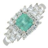 An 18ct gold emerald and vari-cut diamond dress ring.Estimated total diamond weight