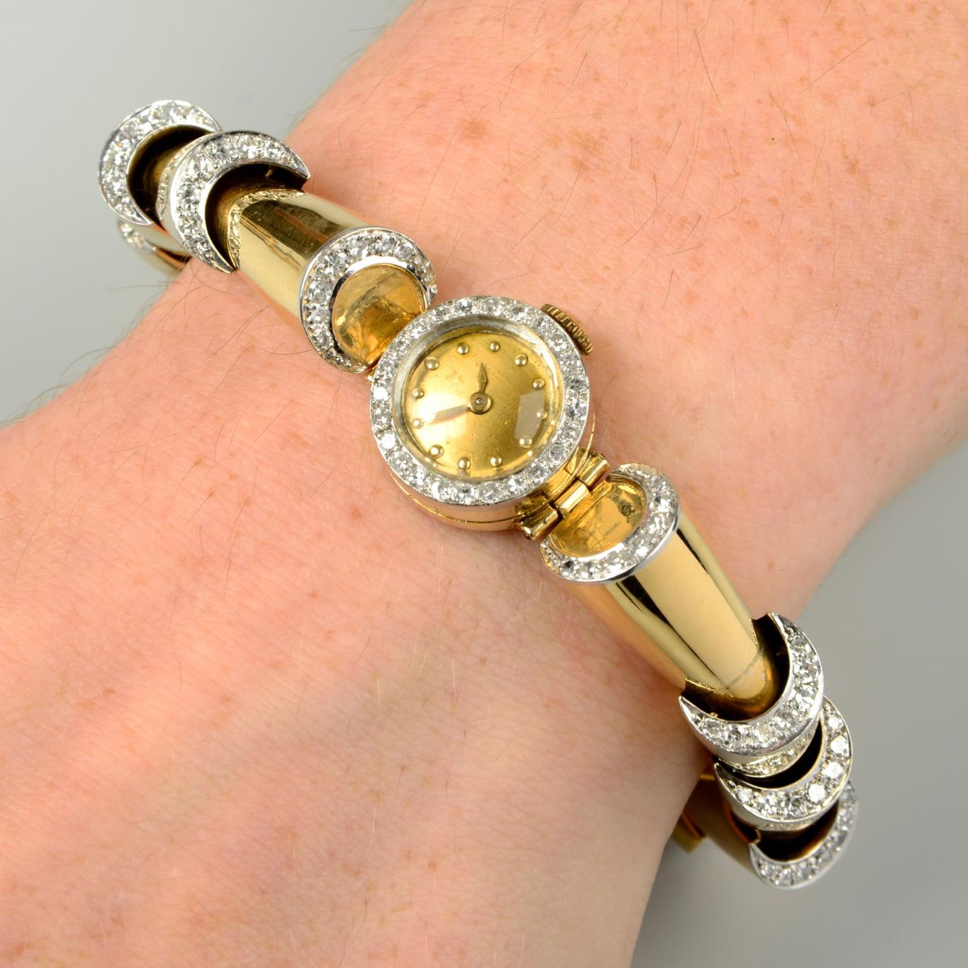 A 1940s gold diamond cocktail watch.Estimated total diamond weight 1.35cts,