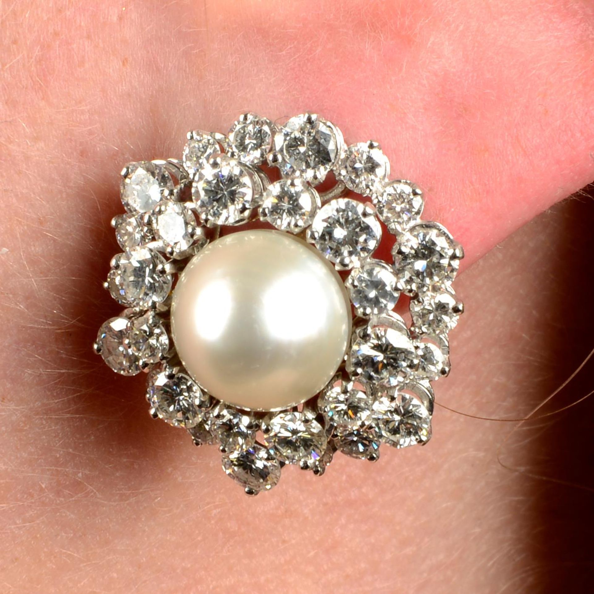 A pair of natural pearl and diamond cluster earrings.With report 77110-13,