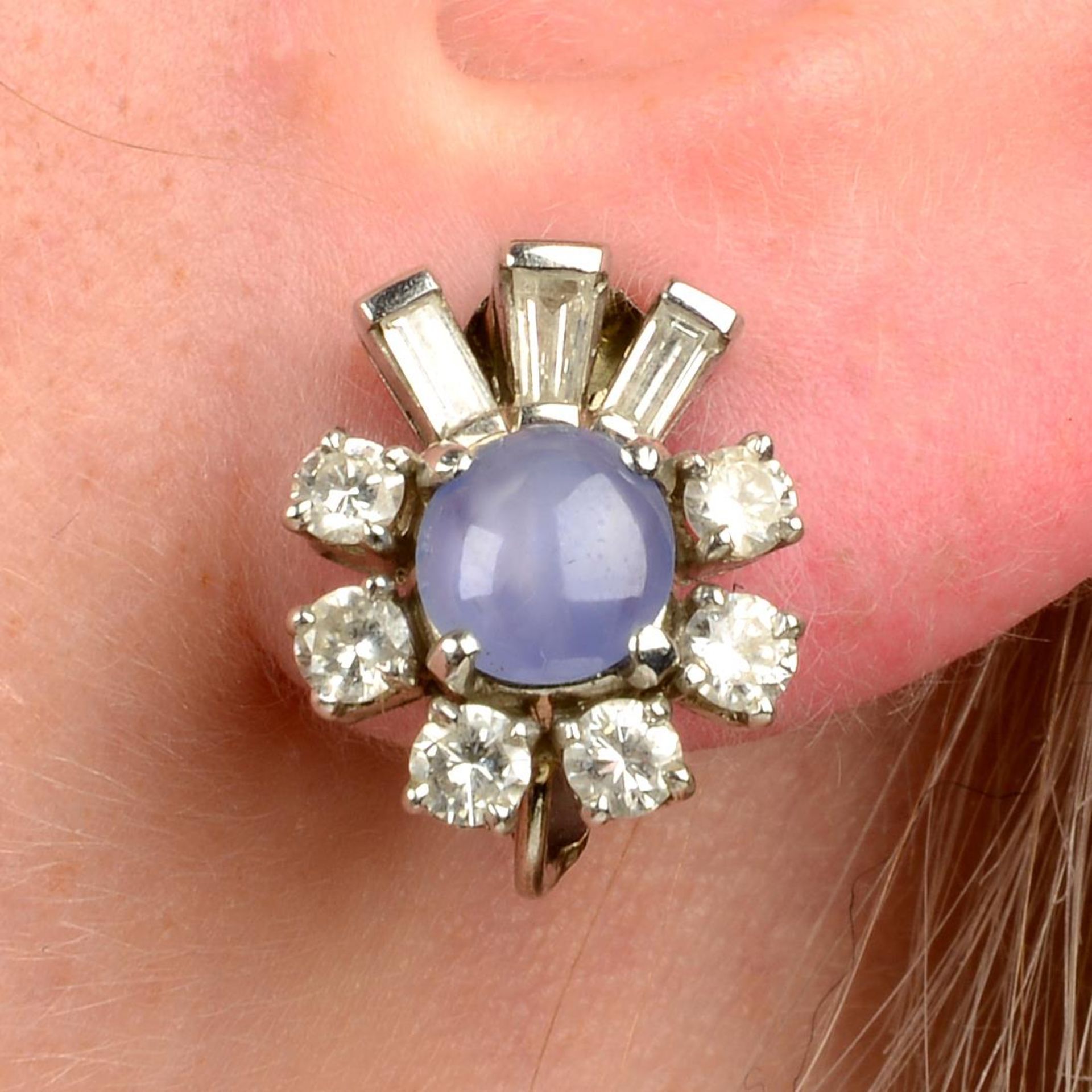 A pair of star sapphire and vari-cut diamond cluster earrings.