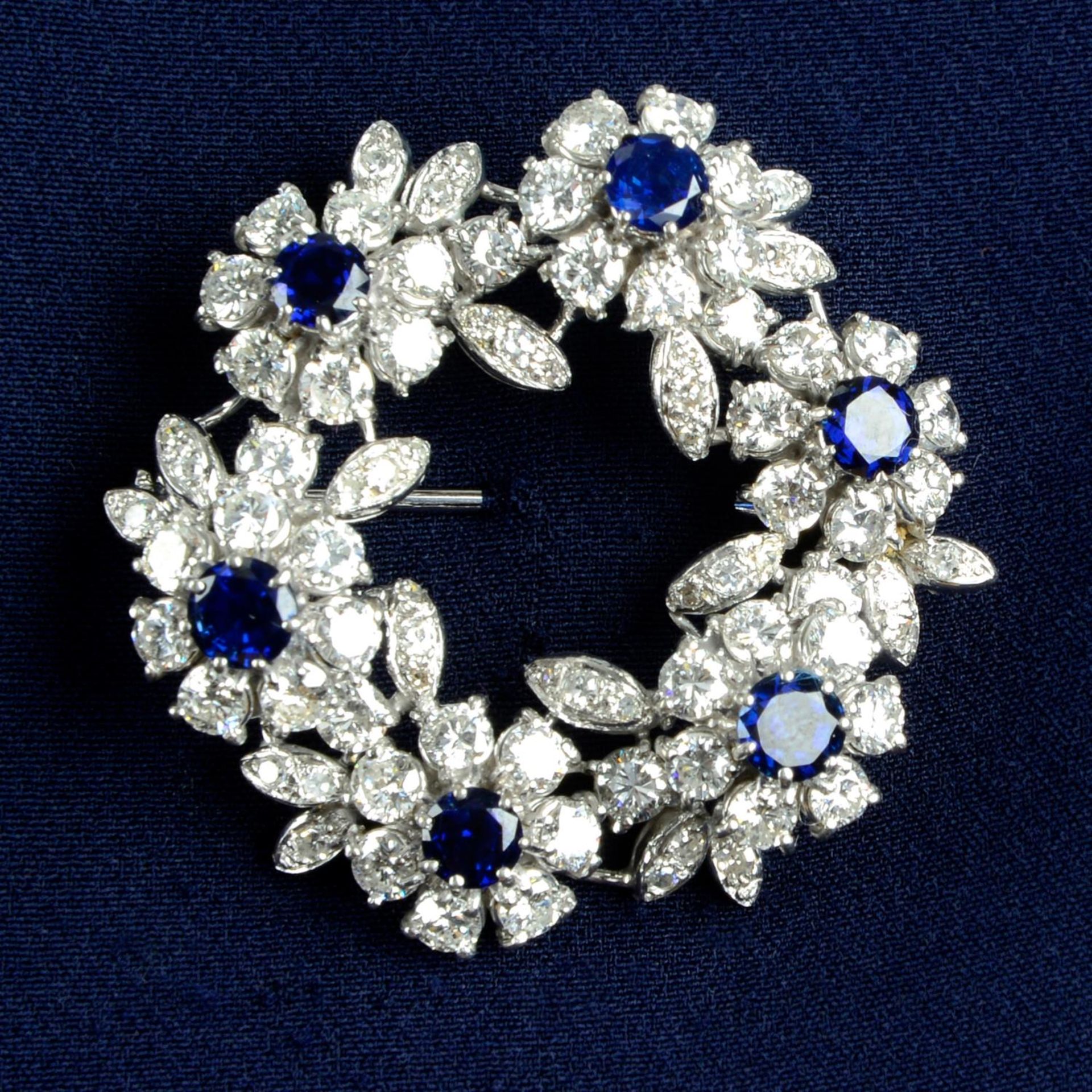 A mid 20th century 18ct gold sapphire and diamond floral wreath brooch.Estimated total sapphire