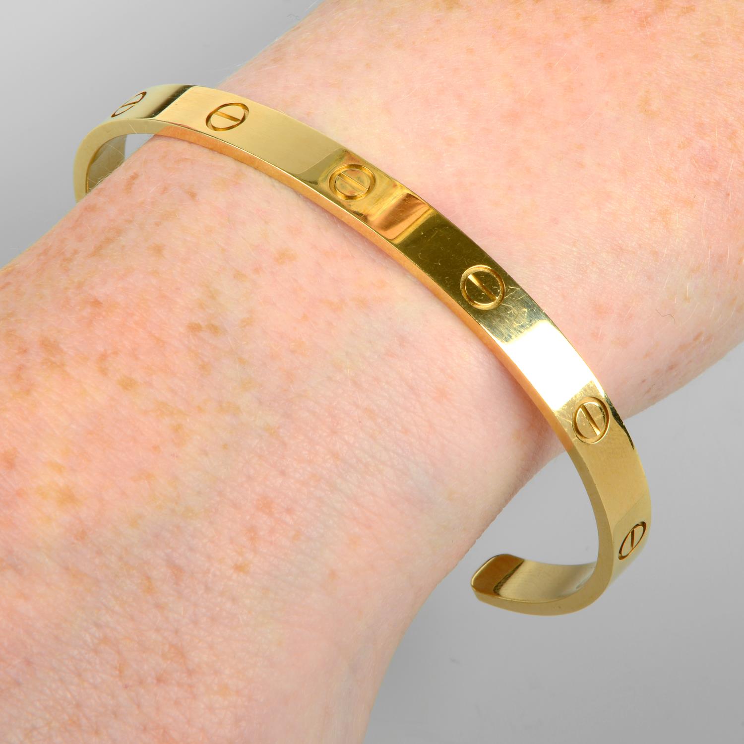 A 'Love' bangle cuff, by Cartier.Stamped 750.