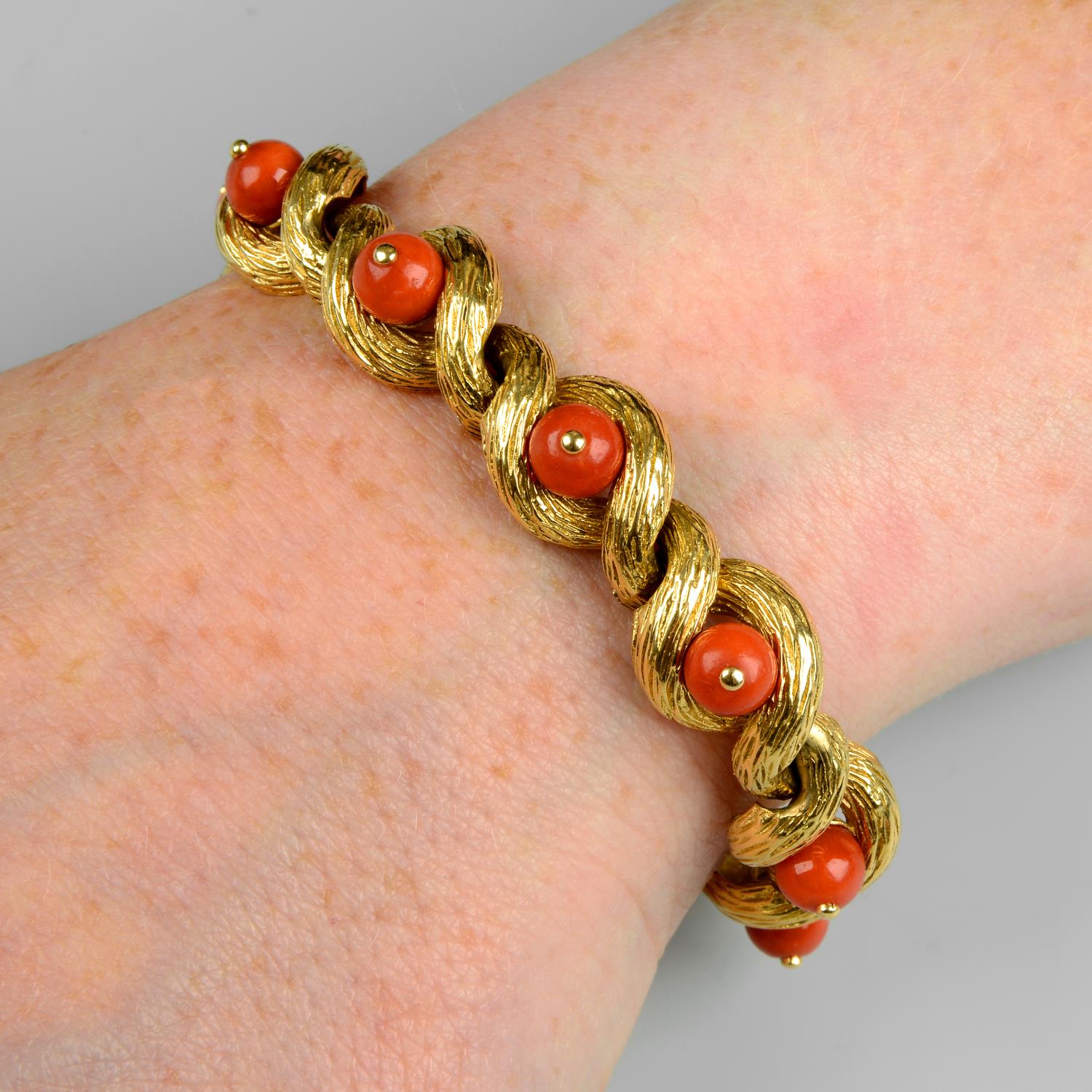 A mid 20th century 18ct gold coral and textured gold bracelet, by Cartier.Stamped 18Kts.