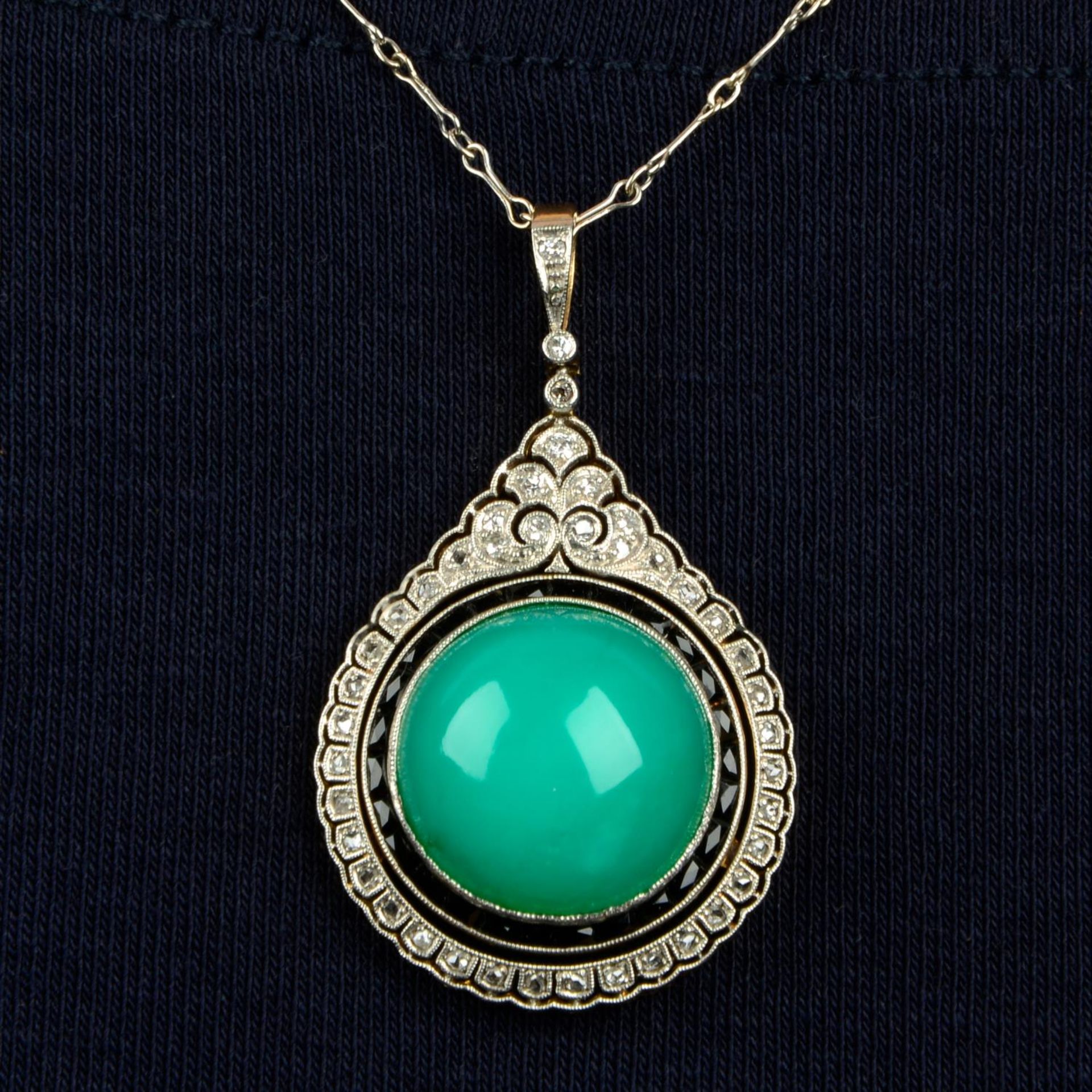 An early 20th century platinum and 18ct gold chalcedony cabochon,