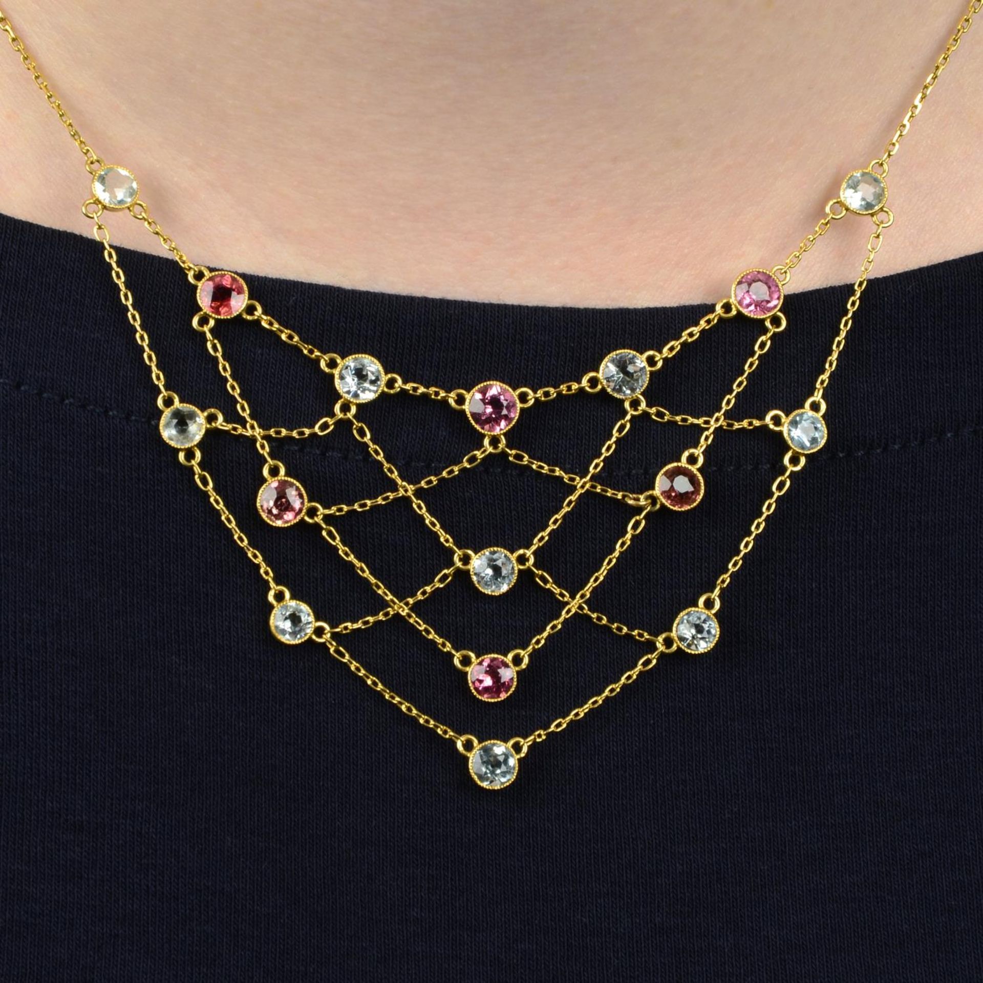 An early 20th century 18ct gold pink tourmaline and aquamarine lattice necklace.Stamped 18.
